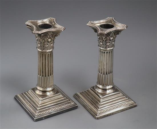 A pair of Edwardian silver dwarf corinthian column candlesticks by Elkington & Co, Birmingham, 1903, 16cm.